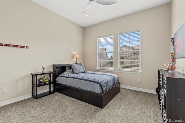 bedroom featuring light colored carpet and ceiling fan