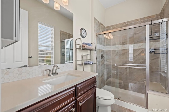 bathroom with toilet, a shower with door, and vanity