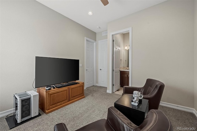 carpeted living room with ceiling fan