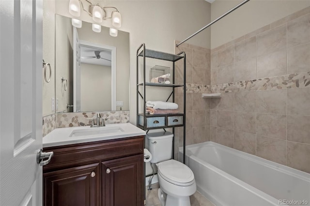 full bathroom with toilet, tiled shower / bath, ceiling fan, and vanity