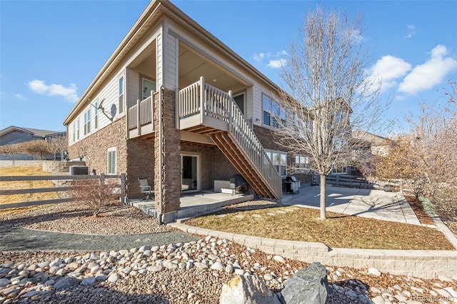 exterior space featuring a balcony, central AC, and a patio area