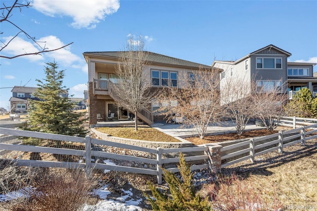 rear view of property with a balcony