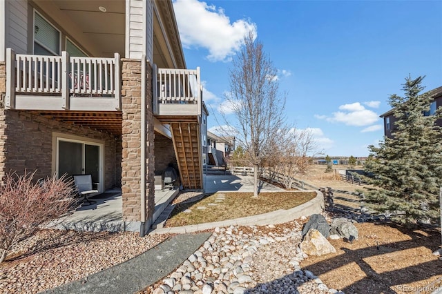 view of side of home with a patio