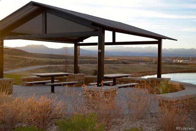 surrounding community with a gazebo and a water and mountain view