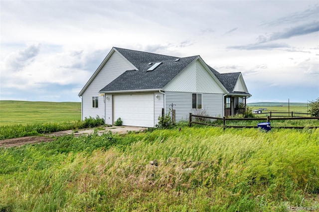 27190 Private Road 139, Agate, CO 80101 - view of side of property featuring a garage, a shingled roof, and driveway