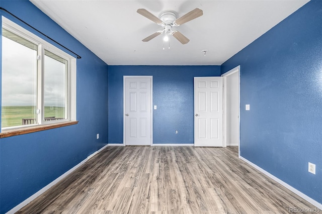 27190 Private Road 139, Agate, CO 80101 - unfurnished bedroom with wood finished floors and a ceiling fan
