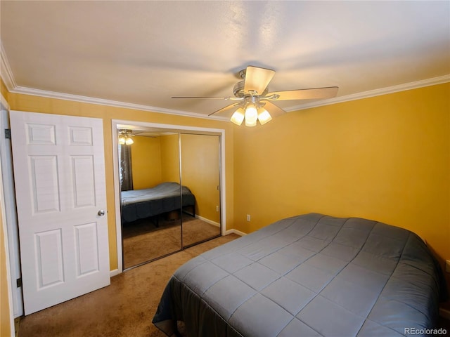 bedroom with a closet, carpet flooring, ornamental molding, baseboards, and a ceiling fan