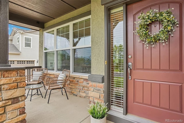 2605 Gray Wolf Loop, Broomfield, CO 80023 - property entrance with a porch, stucco siding, and stone siding