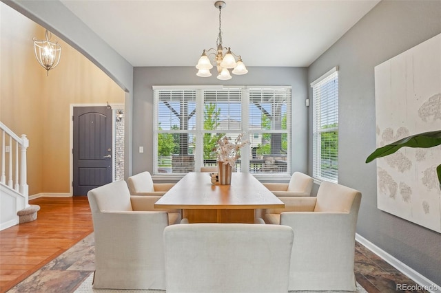 2605 Gray Wolf Loop, Broomfield, CO 80023 - dining area featuring a chandelier, stairway, baseboards, and stone finish flooring