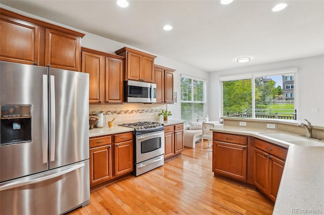 2605 Gray Wolf Loop, Broomfield, CO 80023 - kitchen featuring stainless steel appliances, light countertops, recessed lighting, a sink, and brown cabinetry