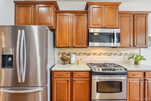 2605 Gray Wolf Loop, Broomfield, CO 80023 - kitchen featuring stainless steel appliances, brown cabinets, and tasteful backsplash