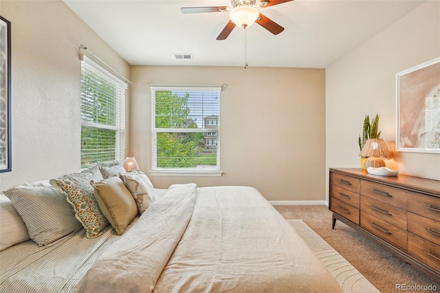 2605 Gray Wolf Loop, Broomfield, CO 80023 - bedroom with light colored carpet, a ceiling fan, and baseboards