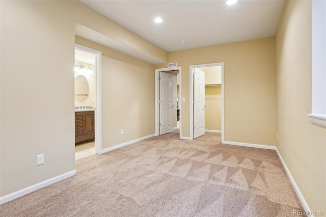 2605 Gray Wolf Loop, Broomfield, CO 80023 - unfurnished bedroom with carpet flooring, recessed lighting, a walk in closet, baseboards, and ensuite bath