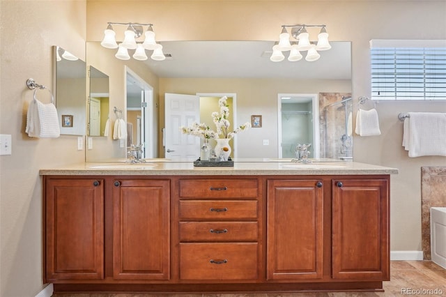 2605 Gray Wolf Loop, Broomfield, CO 80023 - full bath featuring double vanity, a chandelier, a shower stall, and baseboards