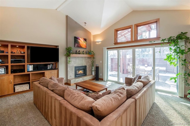 living area with high vaulted ceiling, light carpet, and a tiled fireplace