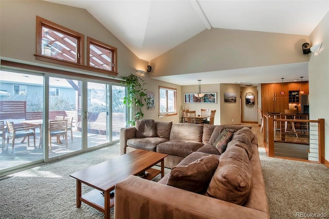 living area featuring carpet floors and high vaulted ceiling