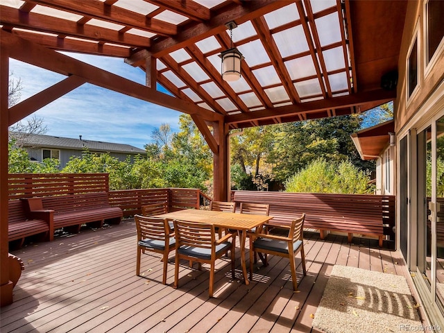 wooden terrace featuring outdoor dining space and a pergola