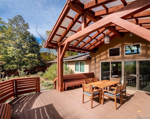 wooden deck featuring outdoor dining space and a pergola