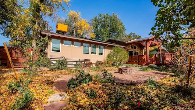 back of property featuring a patio, a deck, and stucco siding