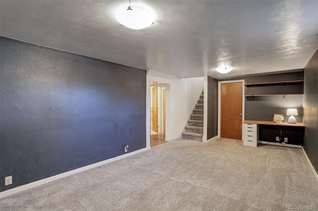 unfurnished living room featuring light colored carpet