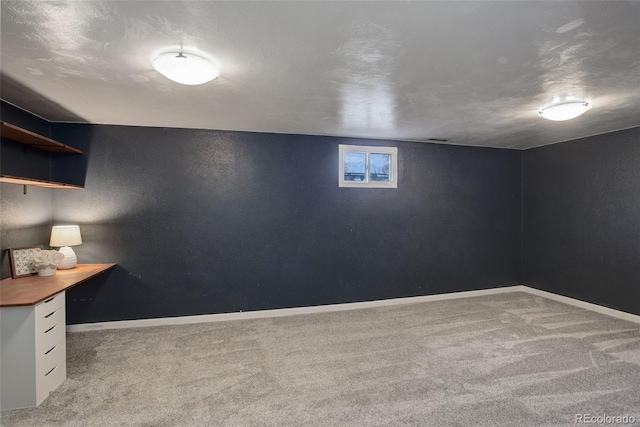 basement featuring a textured ceiling and carpet floors