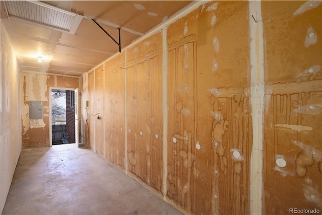 miscellaneous room featuring electric panel and concrete flooring