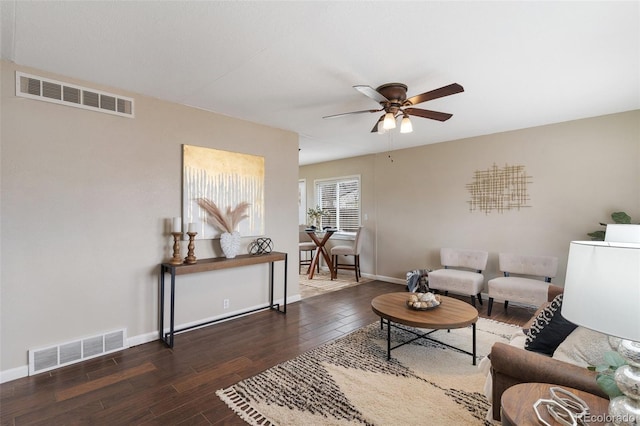 living room with a ceiling fan, wood finished floors, baseboards, and visible vents