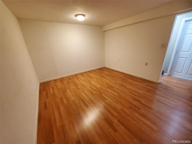 spare room with light wood-style floors and baseboards