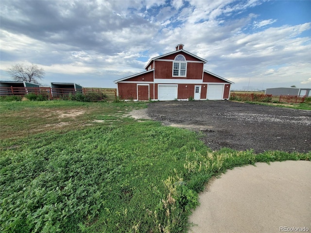 view of barn featuring driveway
