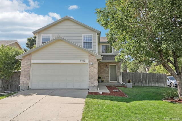 traditional home with a front lawn, fence, driveway, and an attached garage