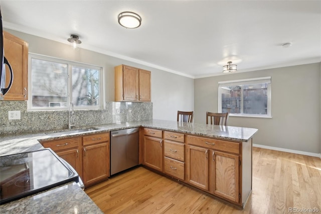 kitchen with a peninsula, a sink, decorative backsplash, light stone counters, and dishwasher