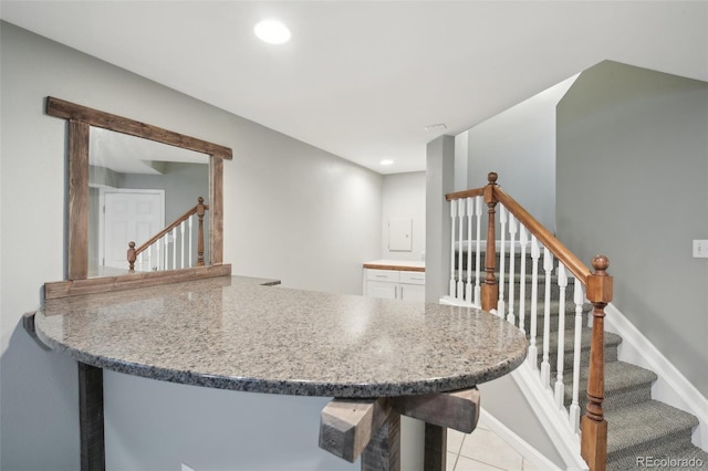 kitchen featuring light tile patterned flooring, recessed lighting, and a peninsula