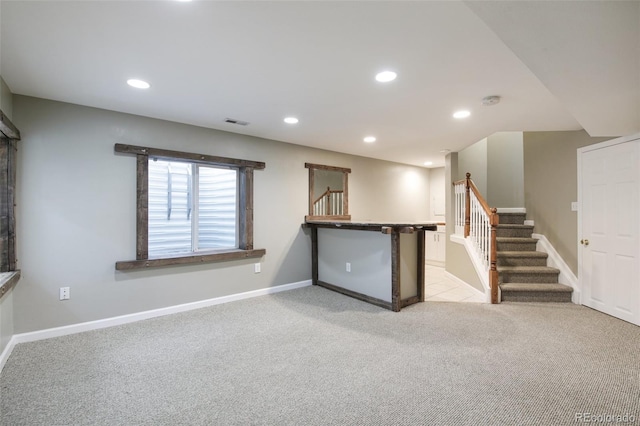 interior space featuring recessed lighting, stairway, baseboards, and light carpet