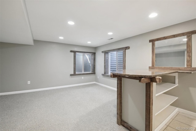 spare room featuring recessed lighting, visible vents, and baseboards