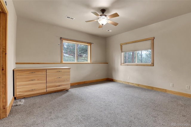 unfurnished bedroom with light colored carpet and ceiling fan