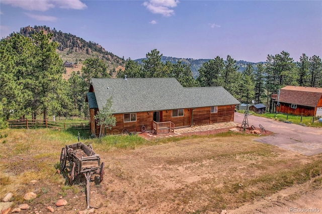 log cabin featuring a mountain view