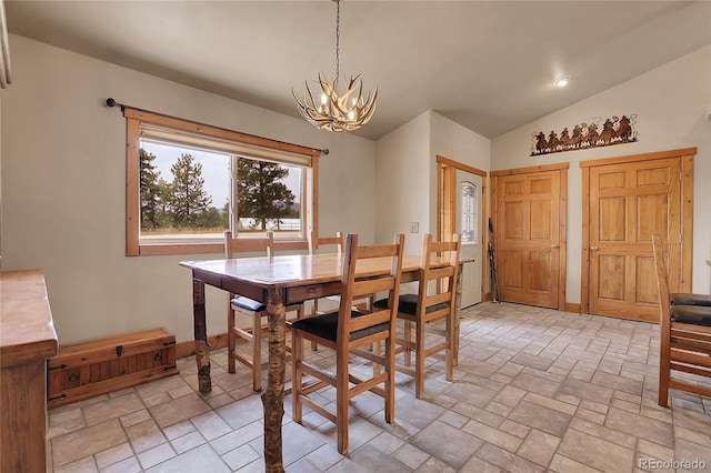 dining room featuring lofted ceiling and an inviting chandelier