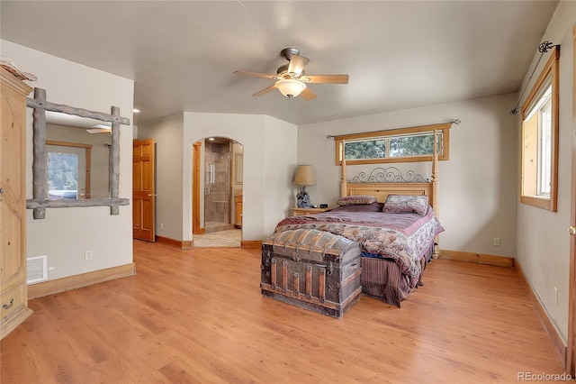 bedroom featuring ceiling fan, light hardwood / wood-style flooring, and ensuite bath