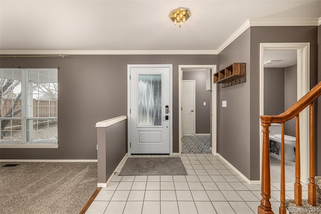 foyer entrance featuring stairway, light tile patterned floors, visible vents, baseboards, and ornamental molding