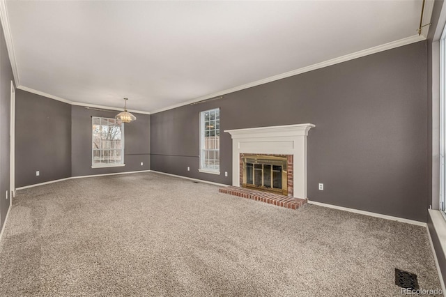 unfurnished living room with visible vents, ornamental molding, carpet floors, a fireplace, and baseboards