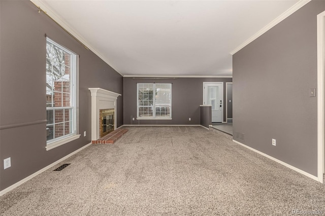 unfurnished living room with plenty of natural light, a fireplace, visible vents, and baseboards