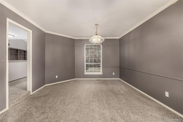 unfurnished room with ornamental molding, baseboards, an inviting chandelier, and carpet floors