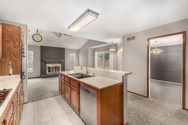 kitchen with visible vents, open floor plan, light carpet, black appliances, and a sink