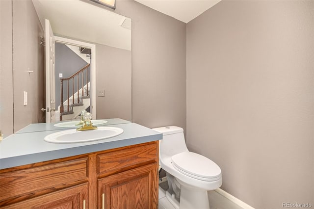 bathroom featuring toilet and vanity