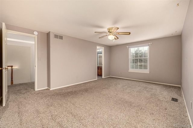 unfurnished room with carpet flooring, visible vents, and ceiling fan