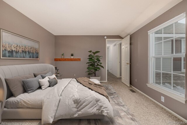 carpeted bedroom with multiple windows, visible vents, and baseboards