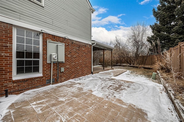 snow covered patio with fence