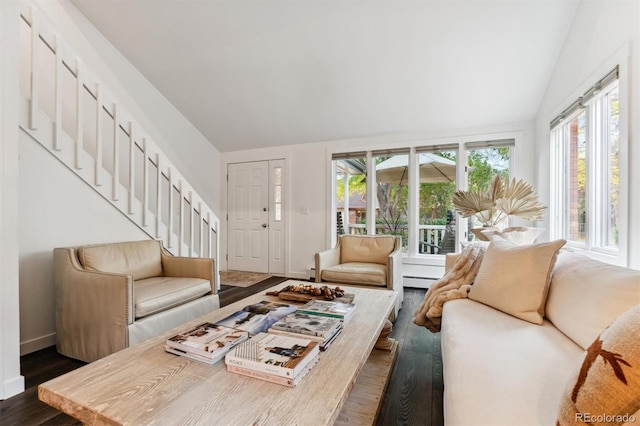 living room featuring dark hardwood / wood-style flooring, a wealth of natural light, vaulted ceiling, and a baseboard radiator