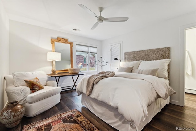 bedroom with baseboard heating, dark hardwood / wood-style flooring, and ceiling fan