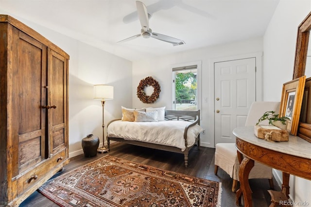 bedroom with ceiling fan and dark hardwood / wood-style floors